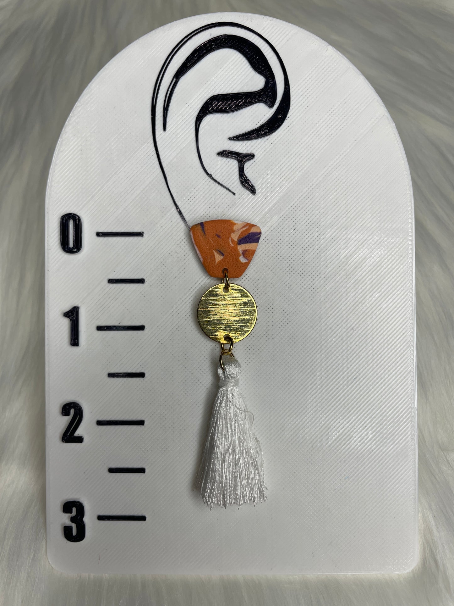 Orange, purple, and white dangles with tassel