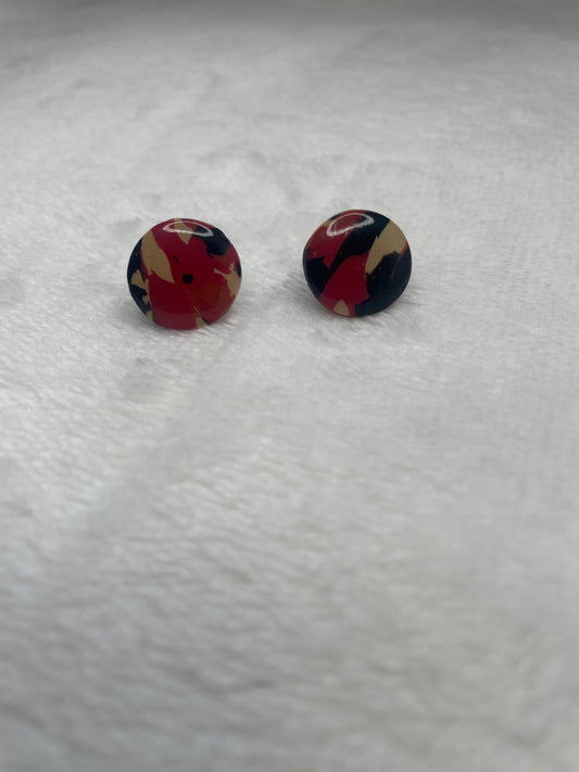 Black, red, orange, and beige marble studs